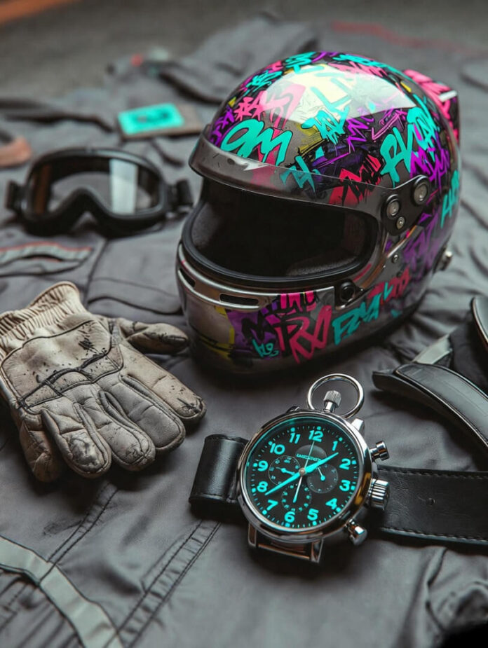 covered helmet placed casually on worn racing gloves